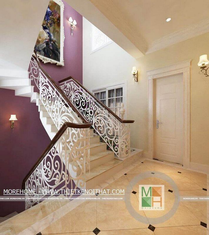 Cầu thang nhà biệt thự với thiết kế họa tiết nghệ thuật bằng sắt phủ sơn trắng kết hợp tay vịn gỗ là điểm nhấn ấn tượng cho không gian tân cổ điển